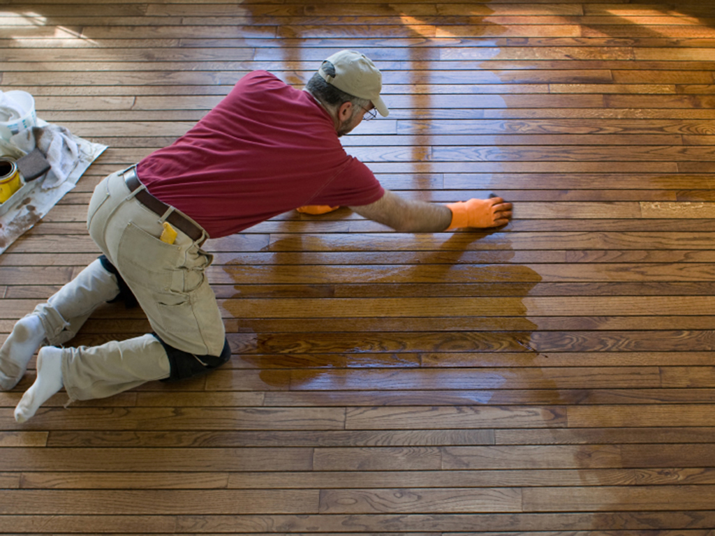 a Hinsdale floor refinisher hard at work updating a wood floor.