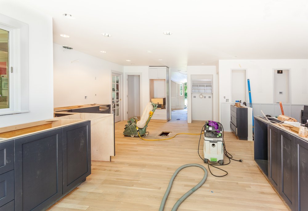 The tools and equipment are seen at work on a wood floor